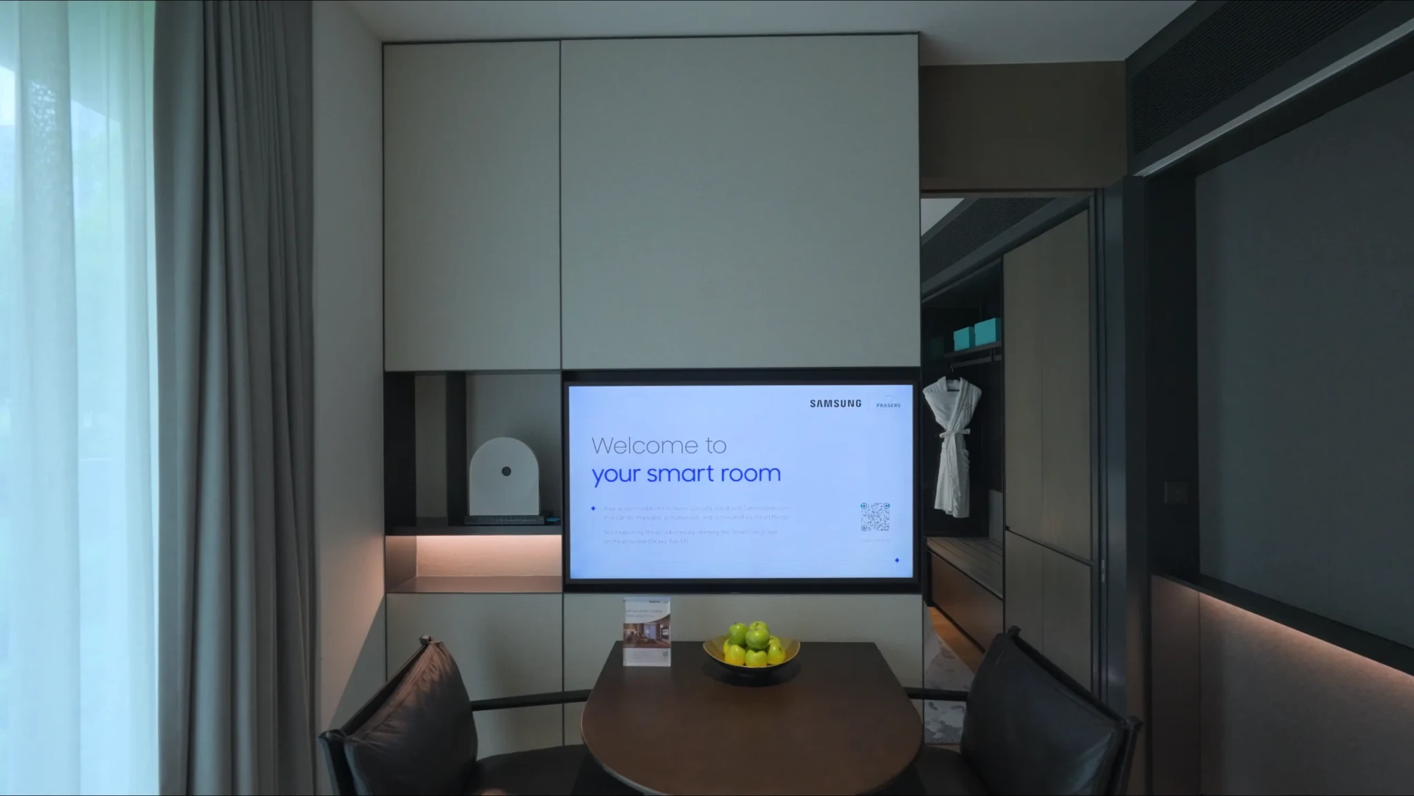 A smart hotel room at Fraser Residence River Promenade featuring Samsung connected devices