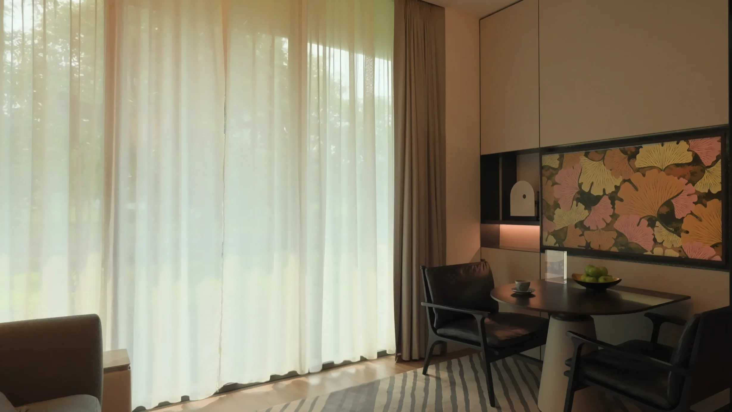 A wall-mounted screen in a Fraser Residence River Promenade smart room showing decorative artwork