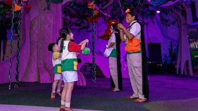 Children with candy bags meeting roving crew during the Sundown session at Curiosity Cove