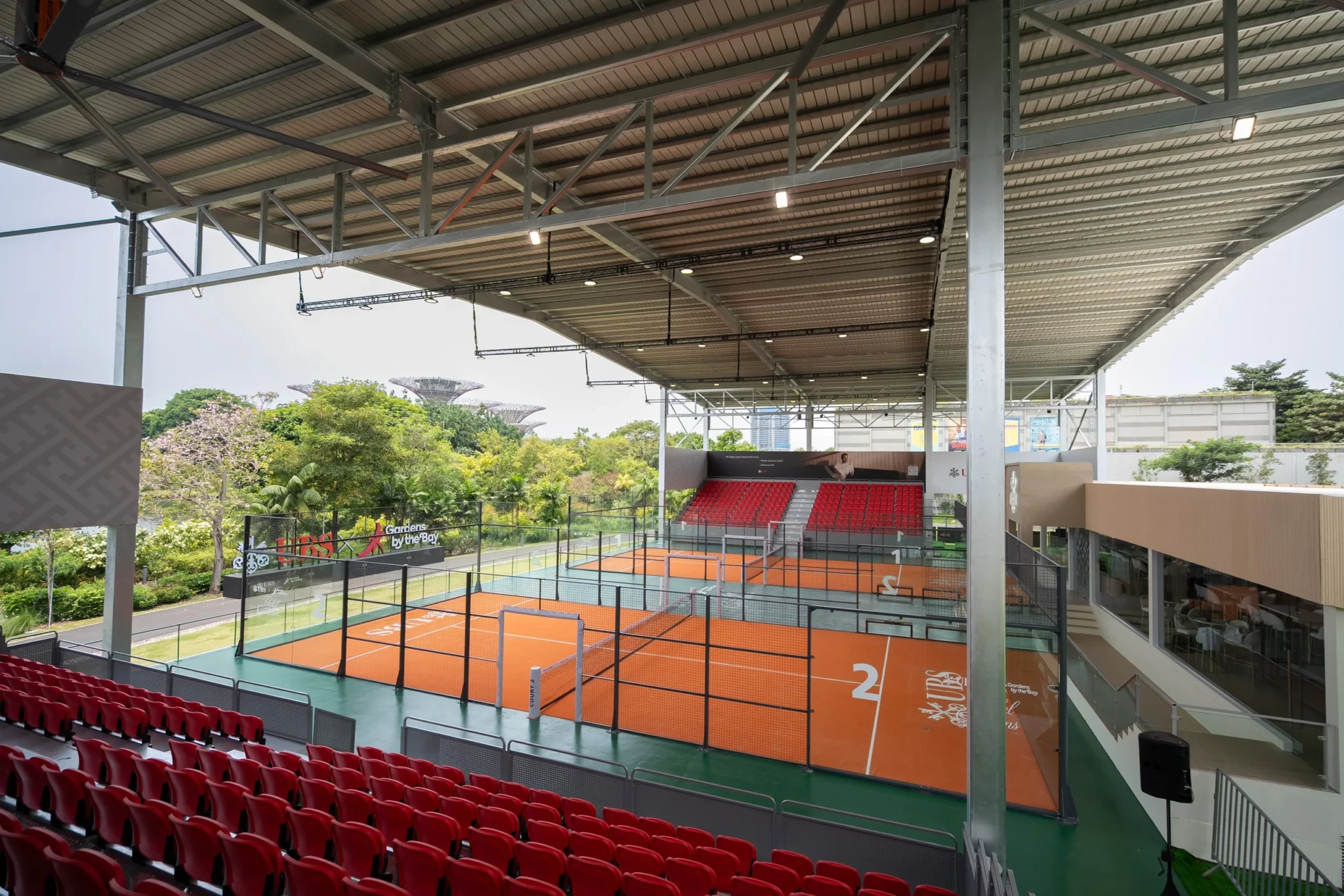 Custom-built padel courts at Gardens by the Bay with the Supertrees visible beyond the landscaping