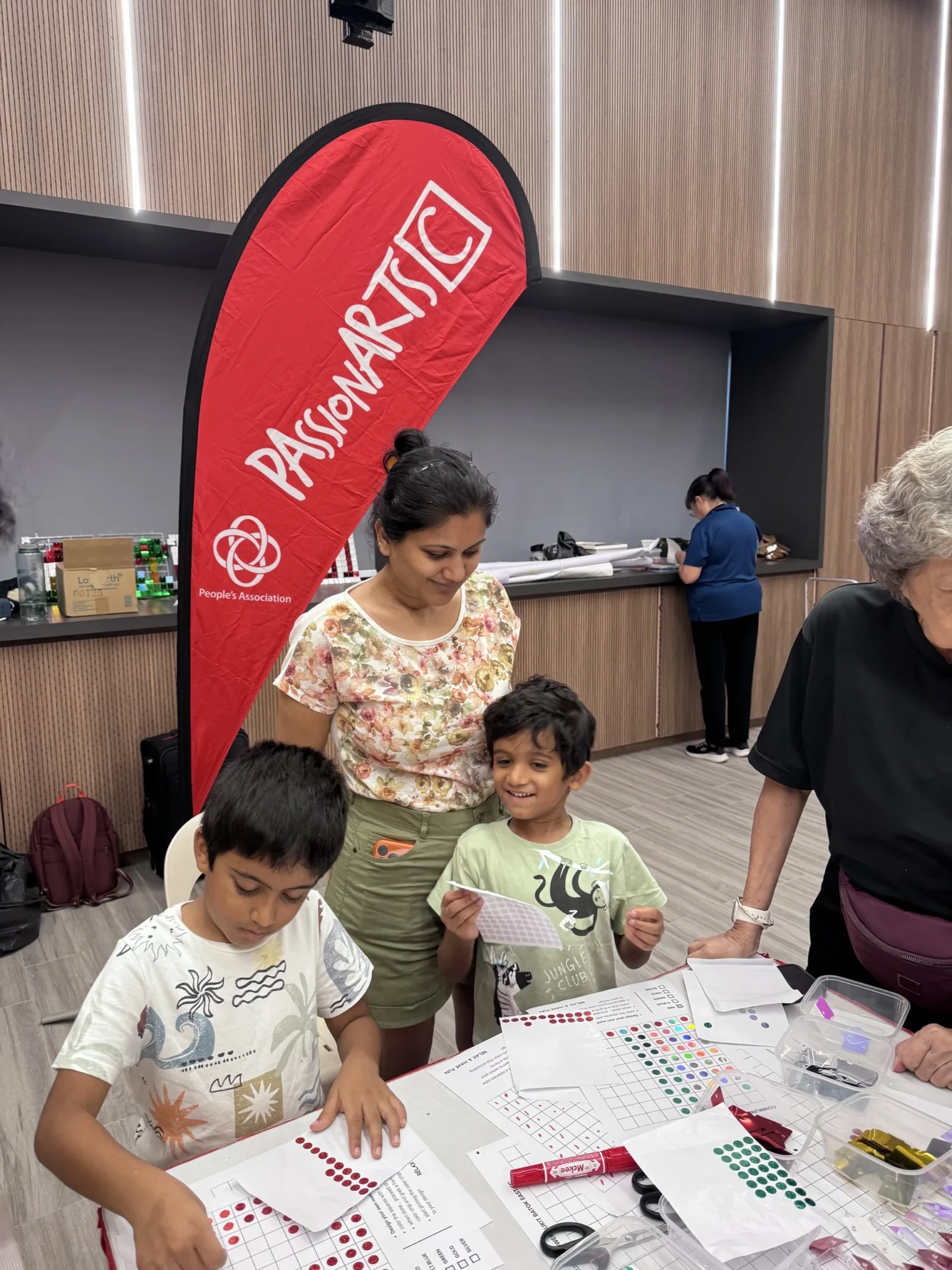 Ms Kanika Jain and her two sons mapping out designs at a Bukit Batok East pre-PAssionArts Festival workshop