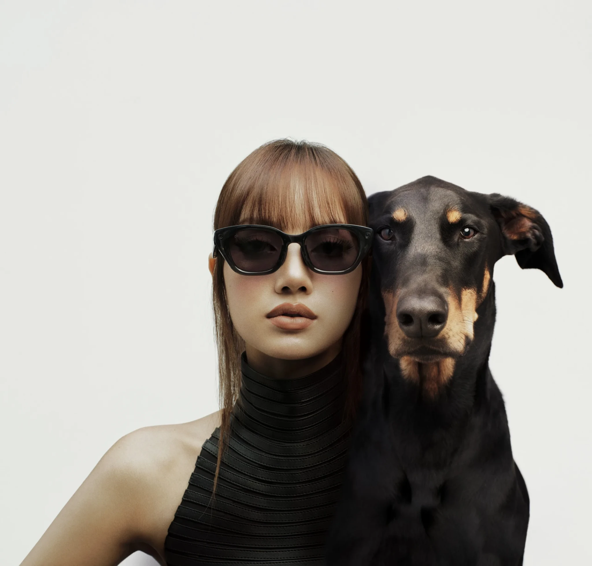 A wearer in the Meta Capri LISA Edition glasses posing with a black and tan dog