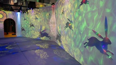 Children's activity space at ACM with immersive projections of Buddhist figures
