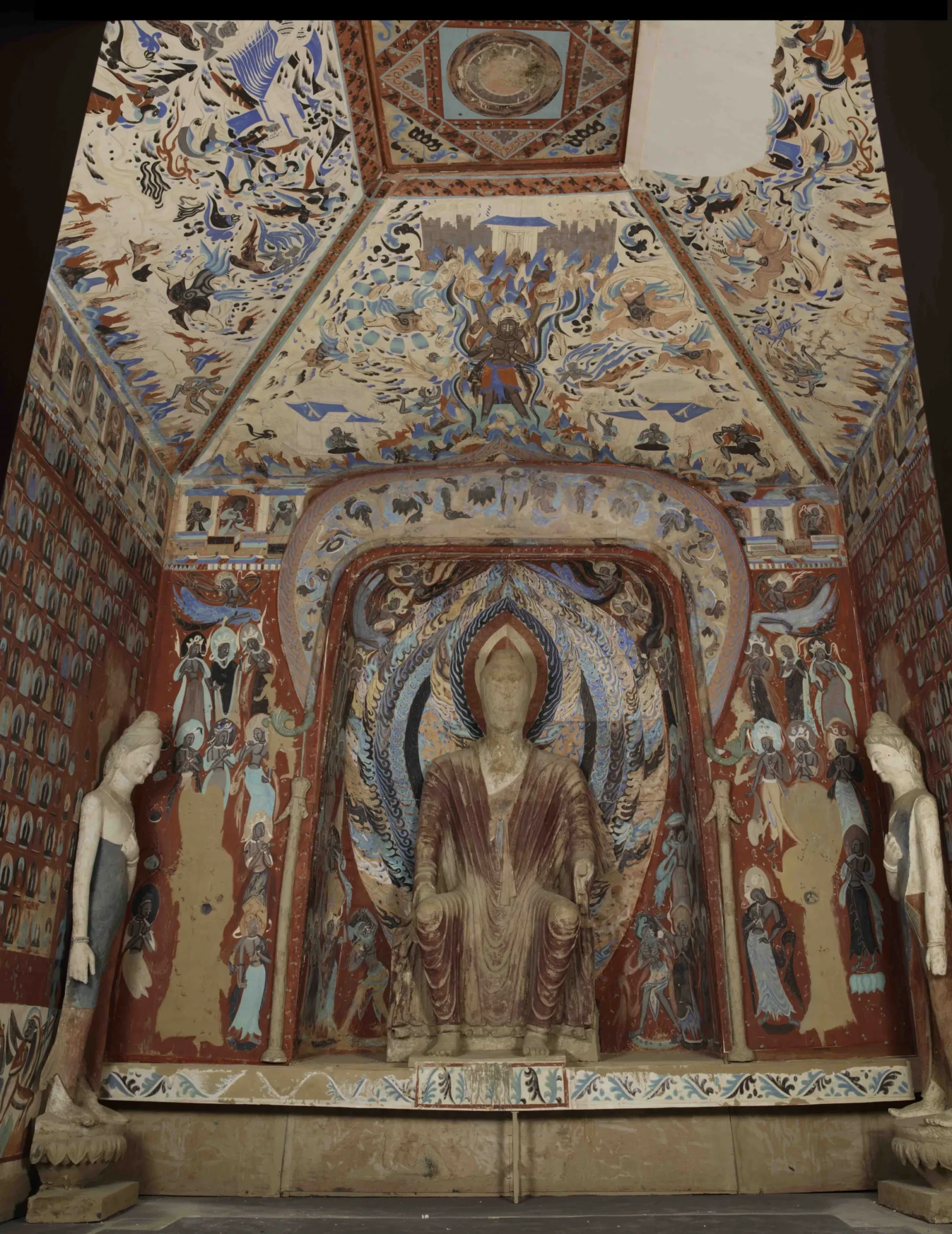 Reproduction of Mogao Cave 249 with a Buddha in its central niche surrounded by painted walls