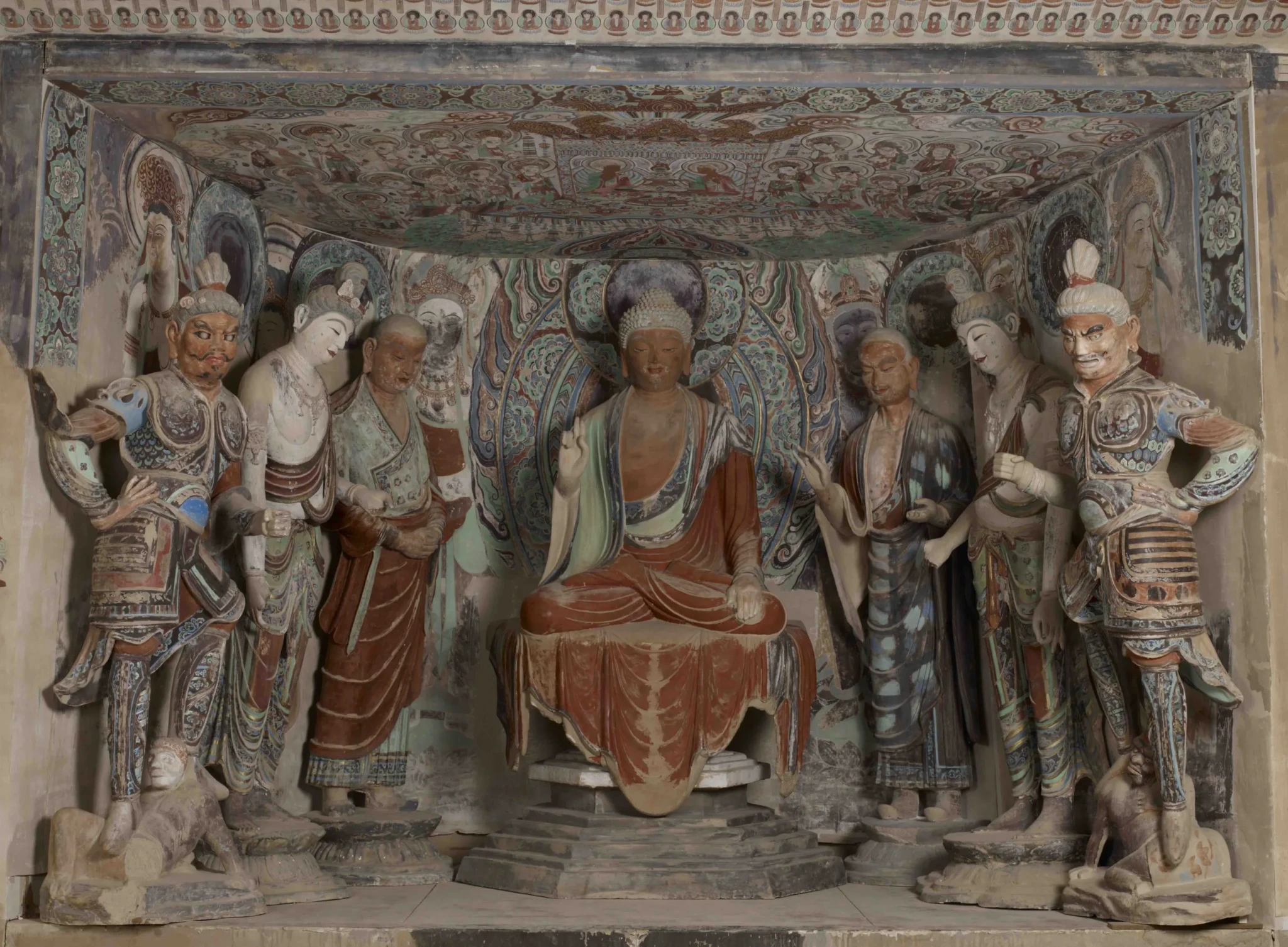 Reproduction of Mogao Cave 45 with a seated Buddha flanked by standing sculptures under a painted ceiling