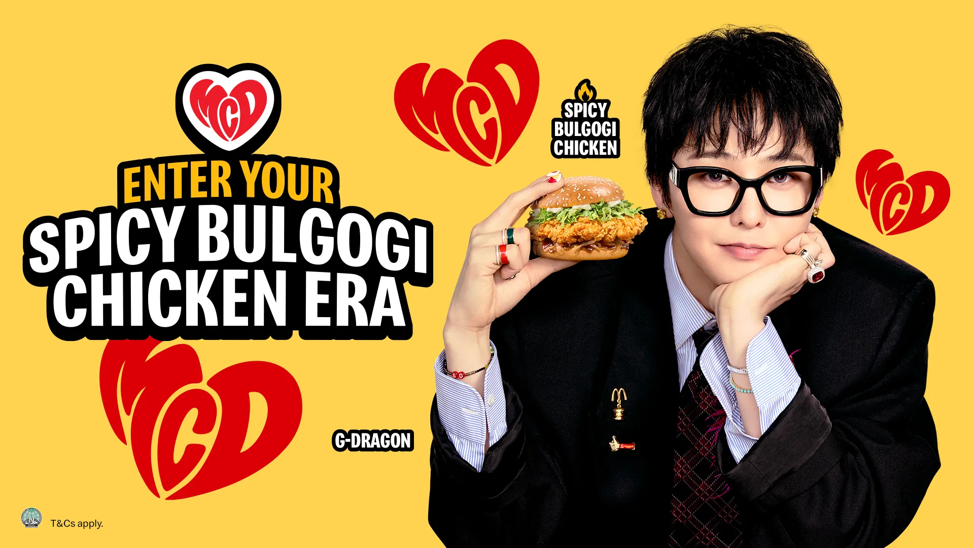 G-DRAGON wearing glasses and black suit holds McDonald's Spicy Bulgogi Chicken Burger
