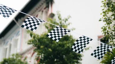 Checkered flags strung overhead across Duxton Hill