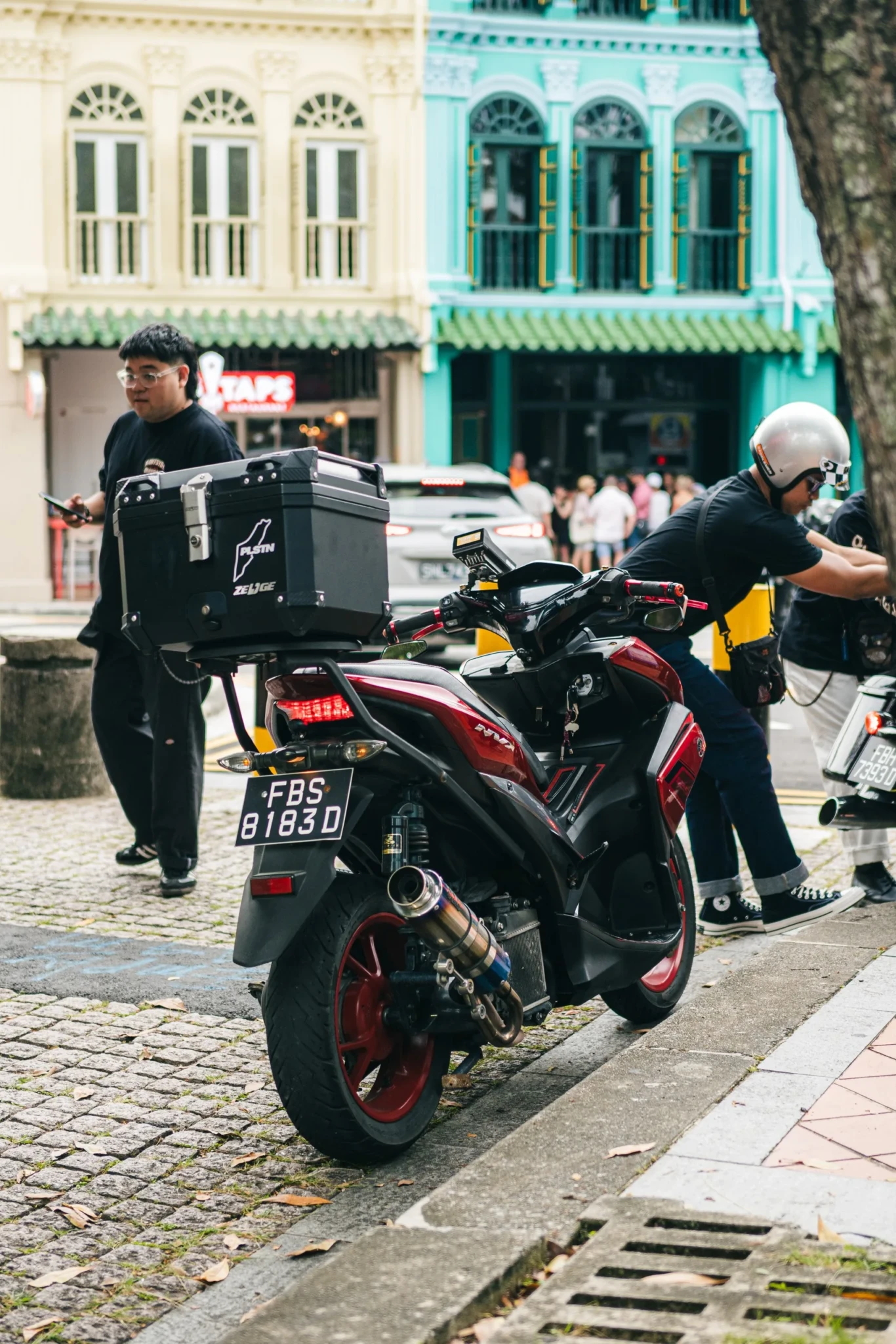 A customised motorbike fitted with a black delivery box