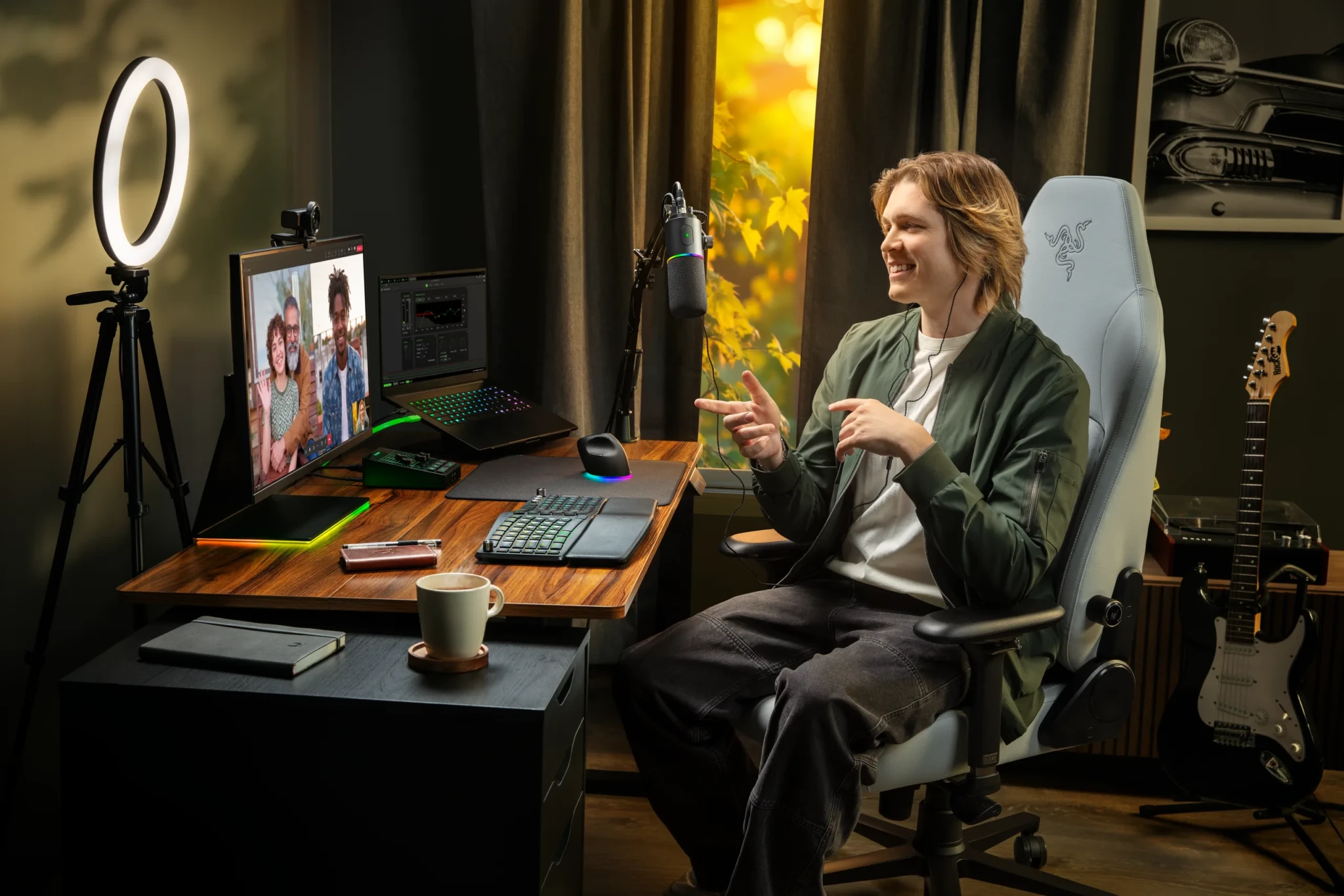 Musician at streaming desk with Razer Kiyo V2 Pro ring light and microphone