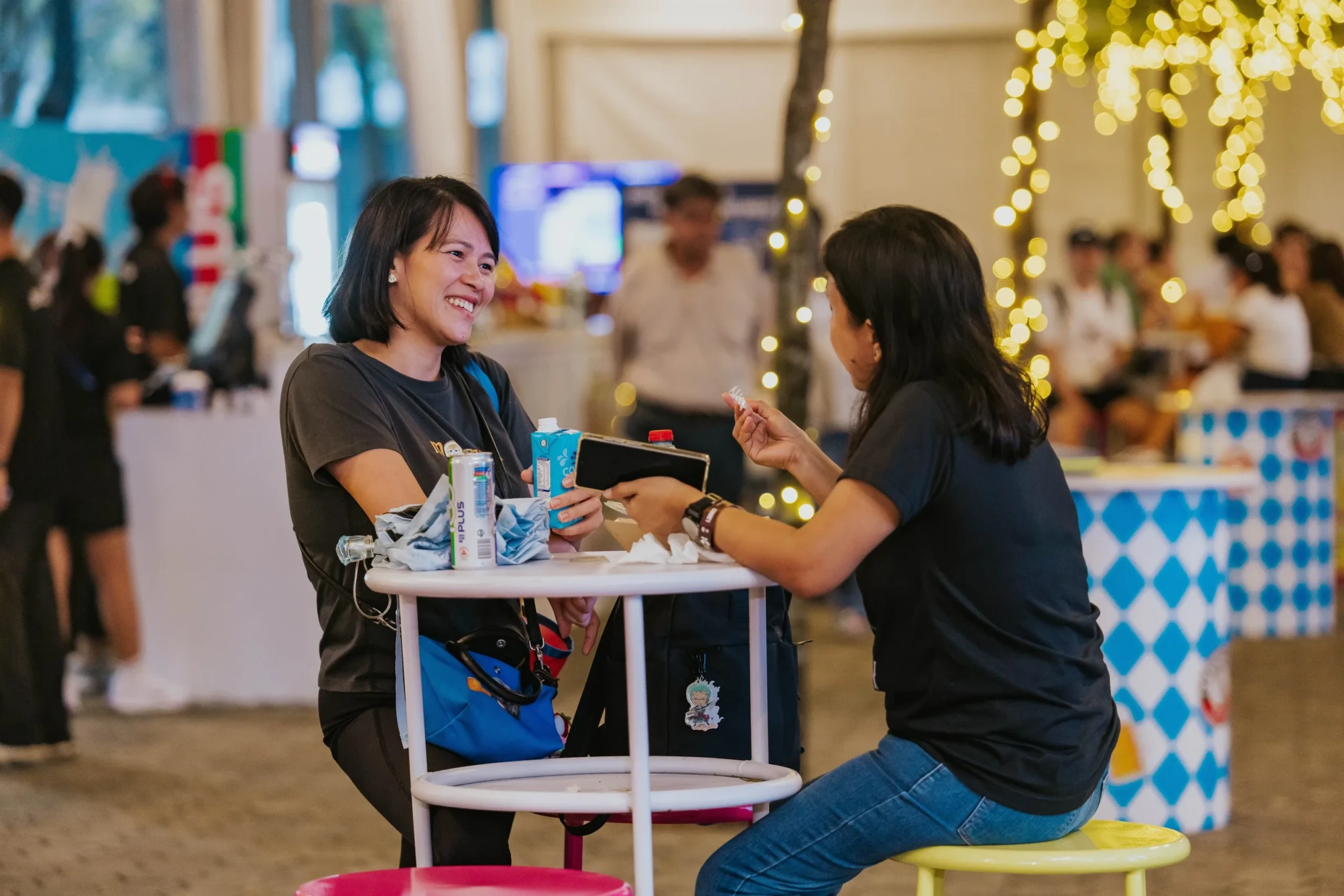 Two visitors relaxing with refreshments at the Break Point Garden at The Kallang