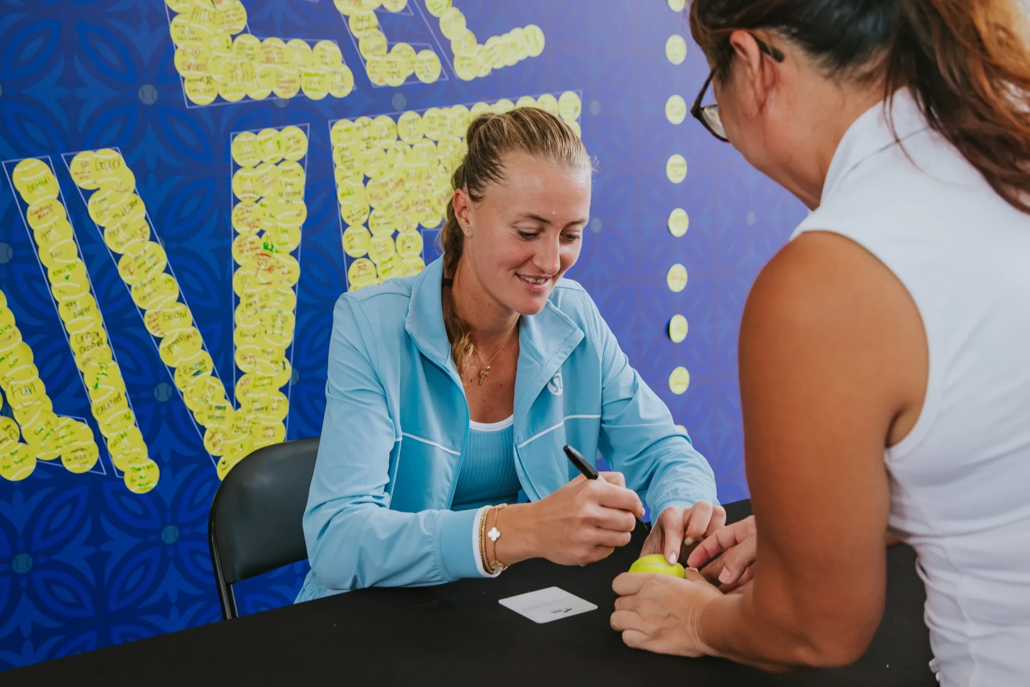 Kristina Mladenovic signing an autograph for a fan at the Singapore Tennis Open