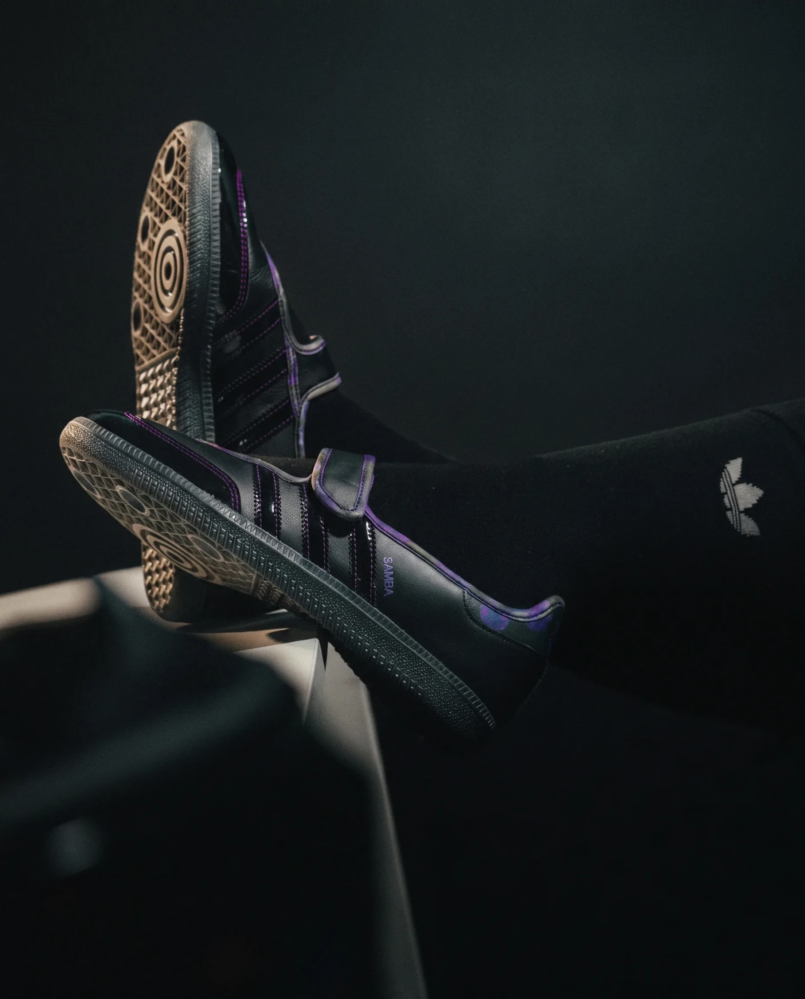 The Black Orchid Samba sneaker showing its cream floral sole pattern and purple accents