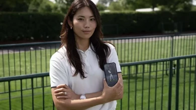 A junior golfer holding a phone that displays Sportsbox AI swing analysis data