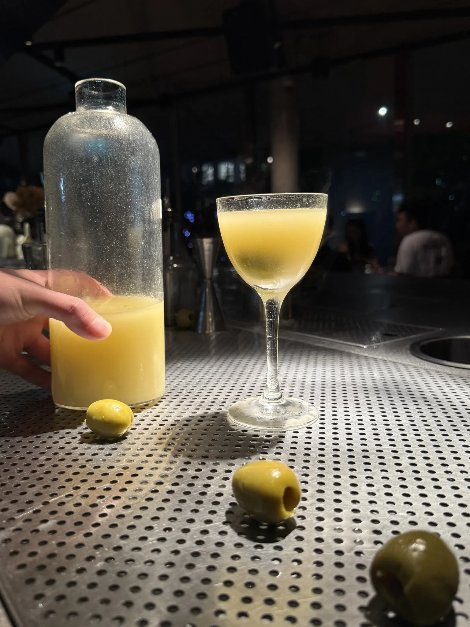 Pale yellow cocktails garnished with green olives at Third Floor