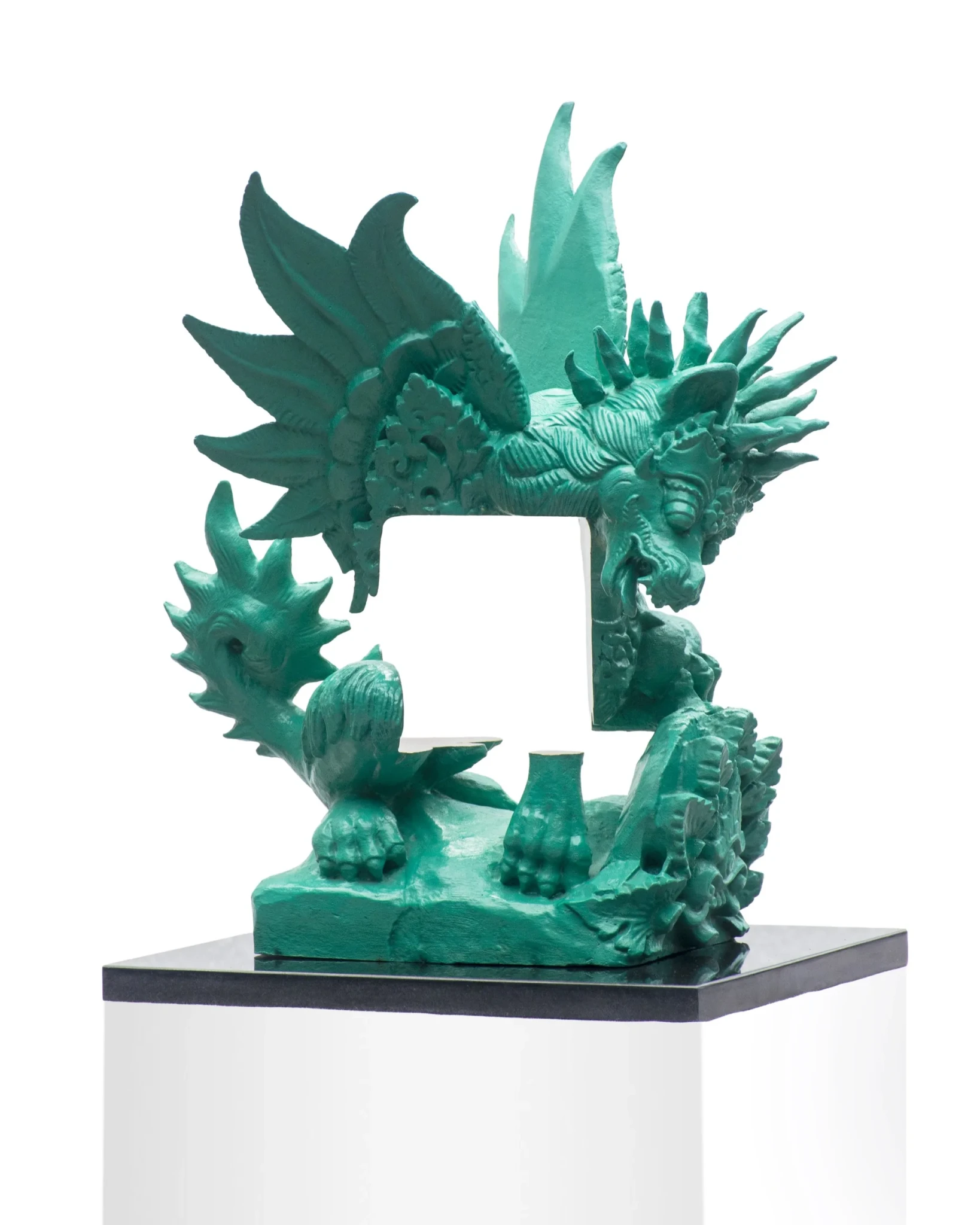 Bronze sculpture with carved Balinese ornamental forms surrounding a rectangular void