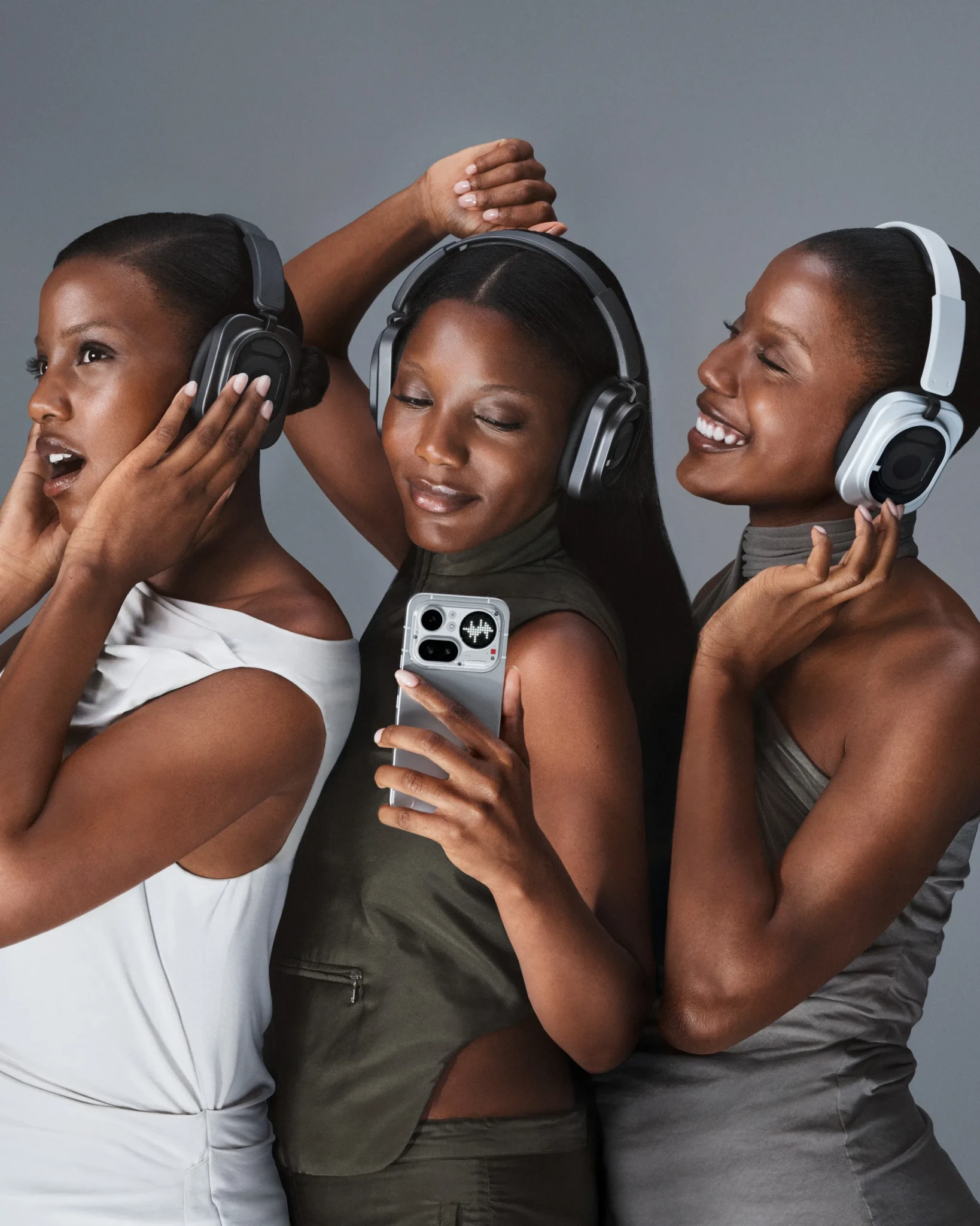 Three models wearing Nothing Headphone (1) Pro in black and white