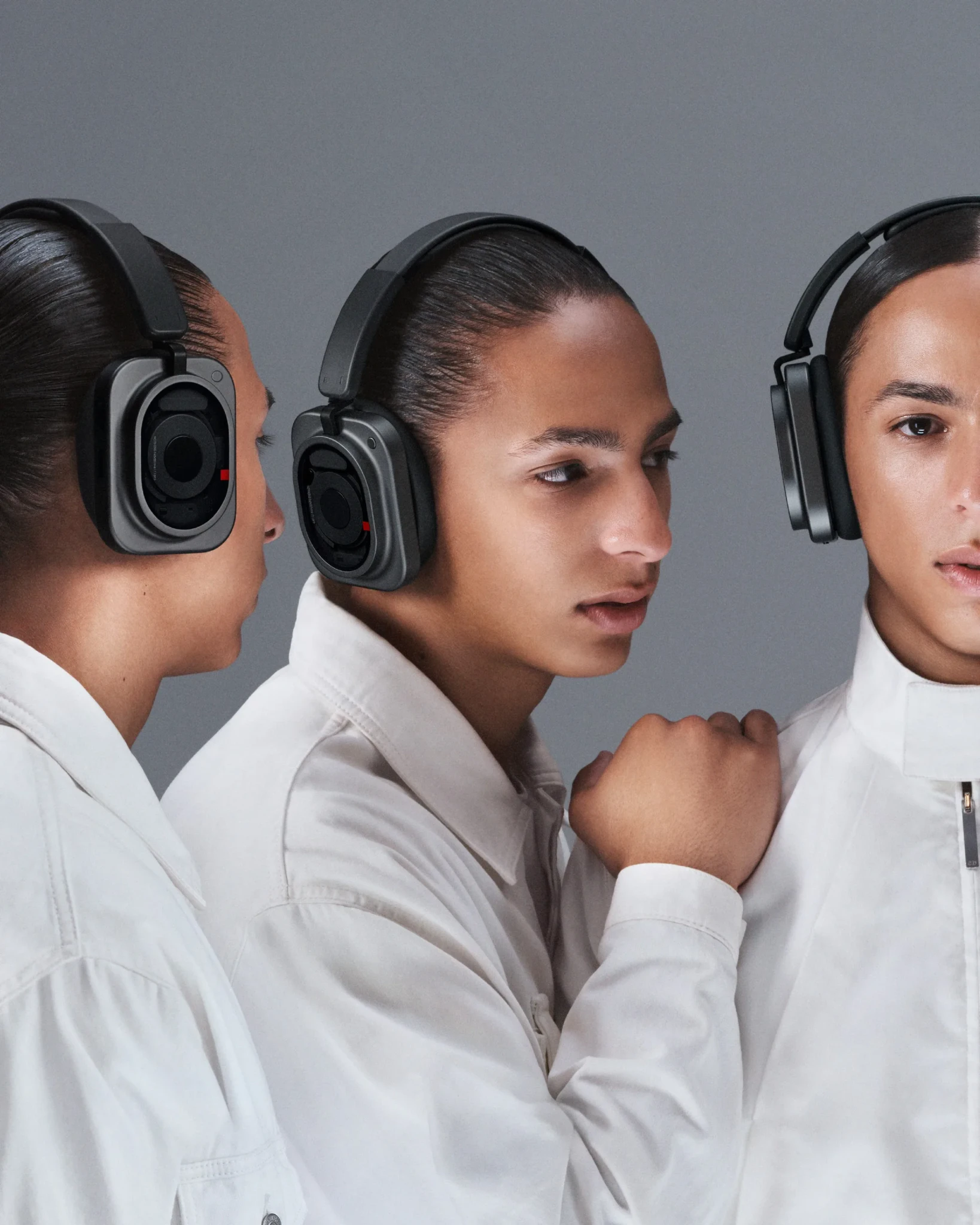 Three models in white shirts wearing Nothing Headphone (1) Pro, seen in profile