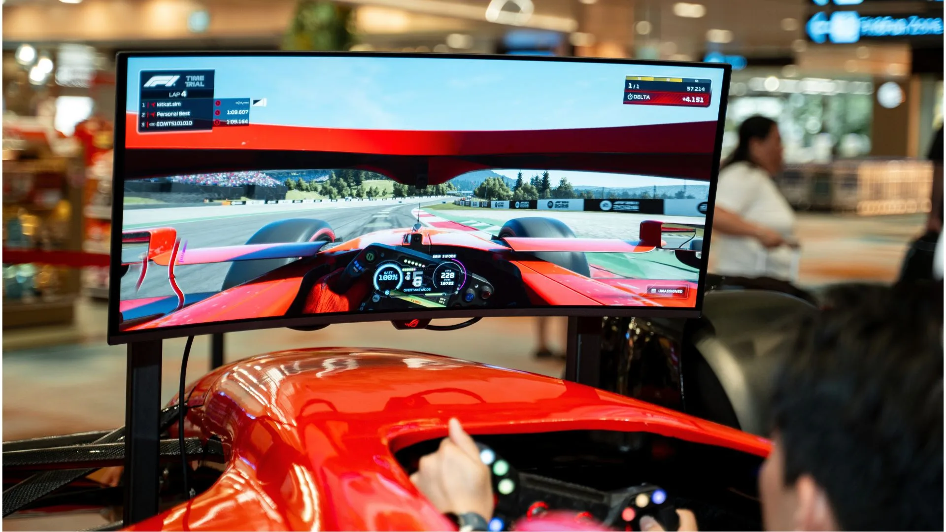 Racing simulator at the Changi 1st KitKat Break Zone showing an F1 cockpit view and leaderboard