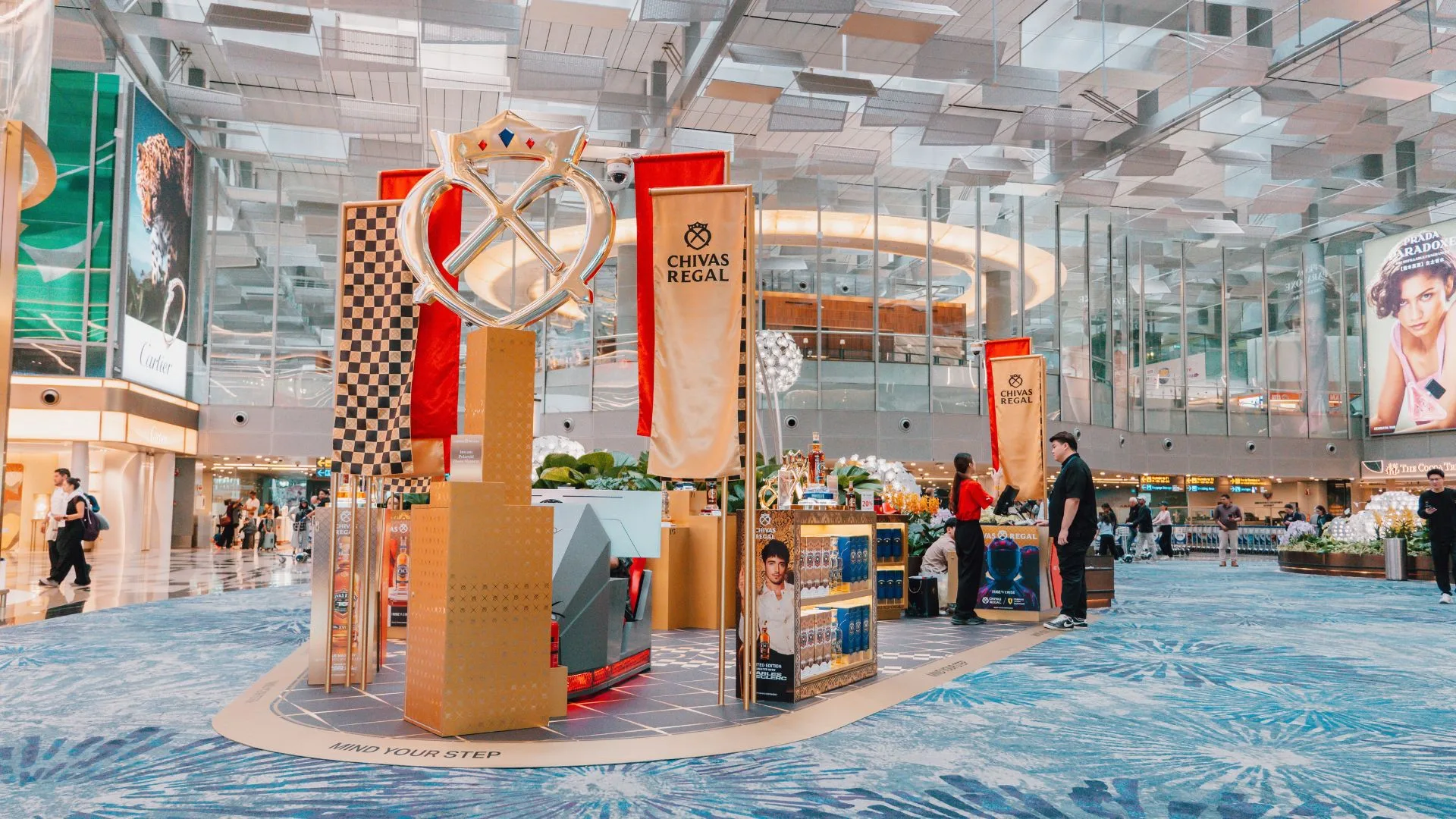 Chivas Regal 16 Charles Leclerc Limited Edition display stand in airport terminal with red and gold design elements