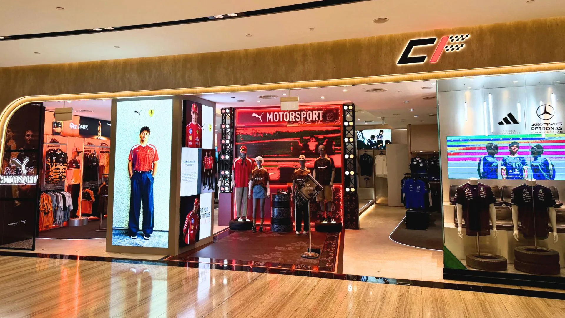 Motorsports retail store with red and black interior, branded displays, and racing team merchandise