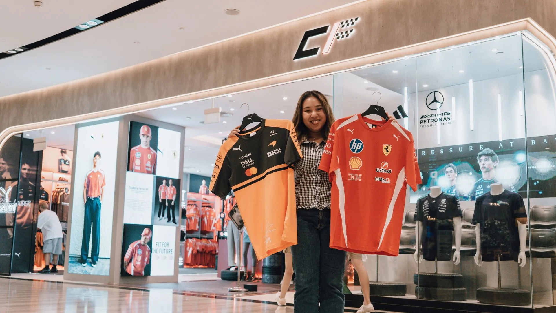 A shopper holds up team apparel at the Chequered Flag store in Jewel