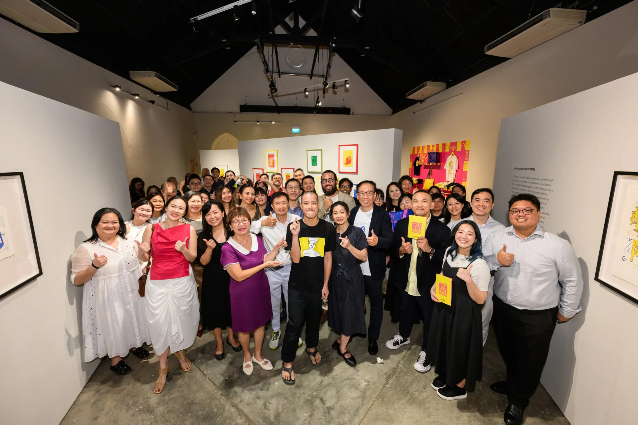 Christian Tan at the centre of a group of guests, supporters and partners at the launch of Held in the Middle