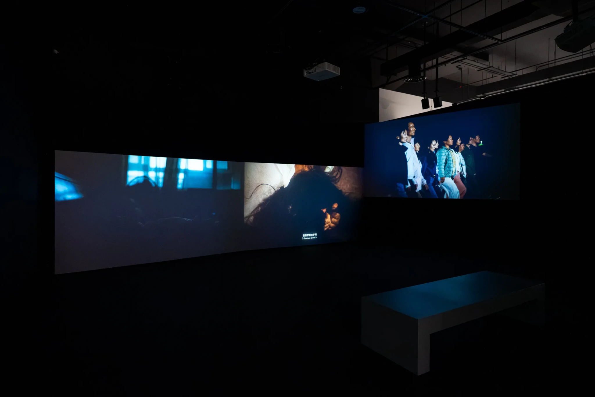 Three large screens showing Hao Jingban's video installation I Witness