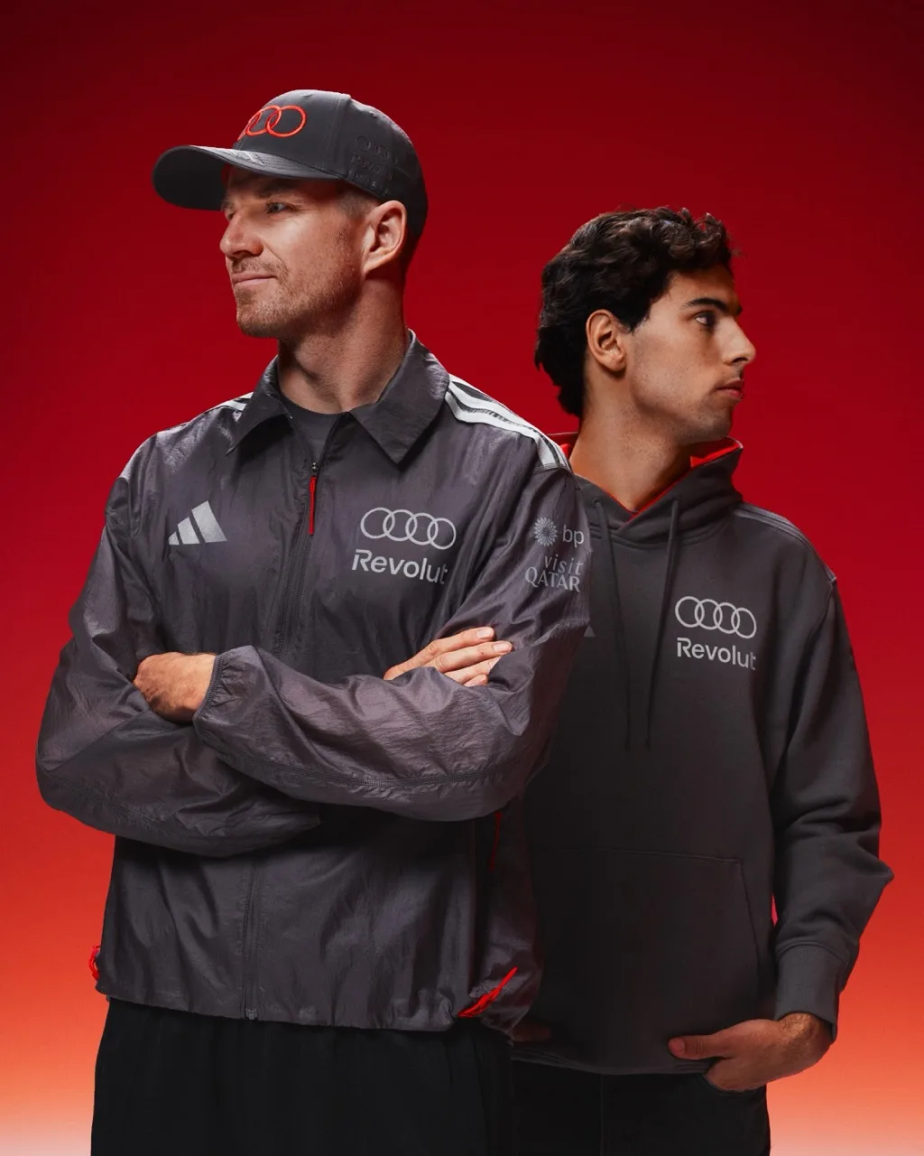 Nico Hulkenberg and Gabriel Bortoleto in adidas motorsport teamwear against a red background