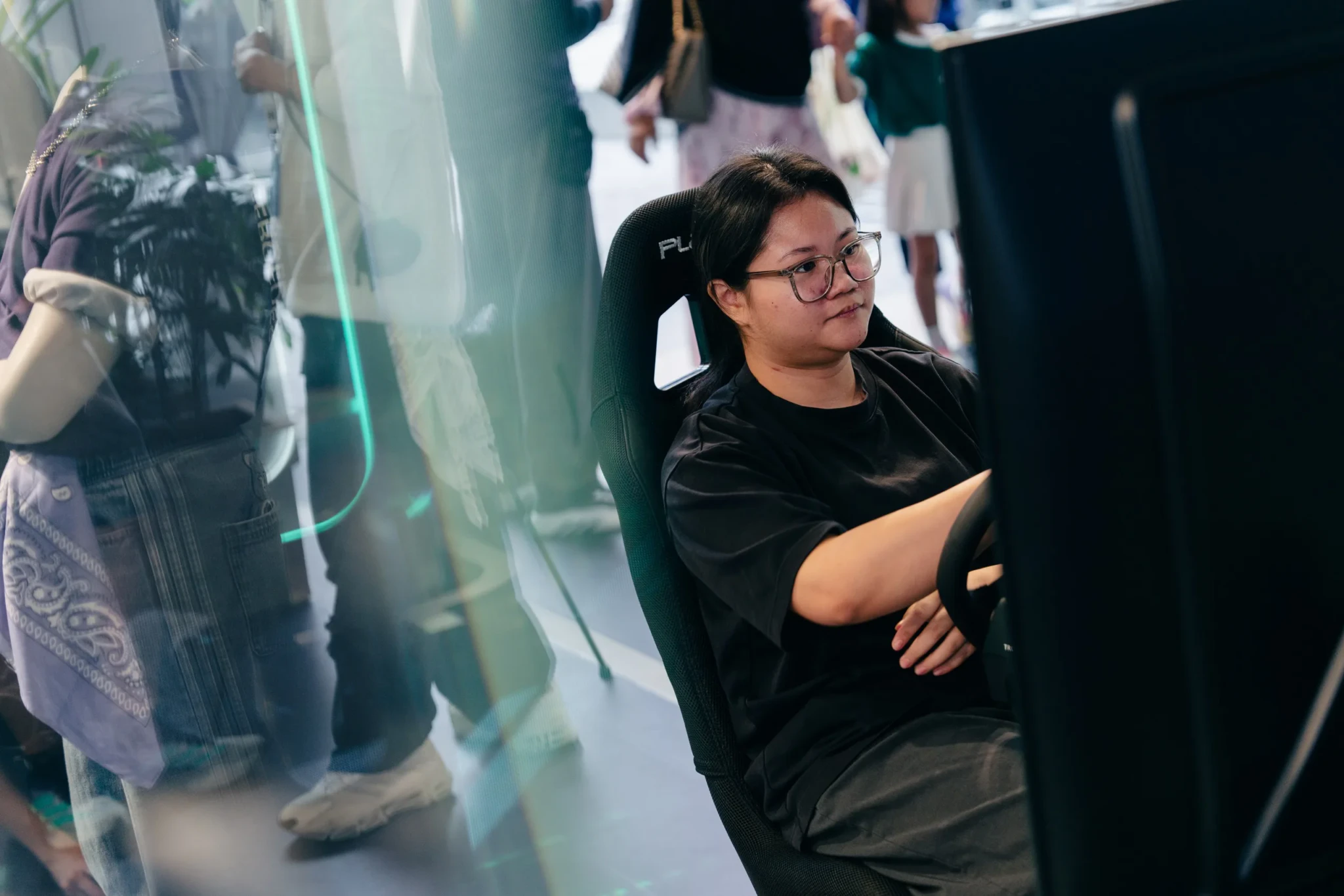 Visitor seated at F1 simulator during adidas race week activation at Raffles City