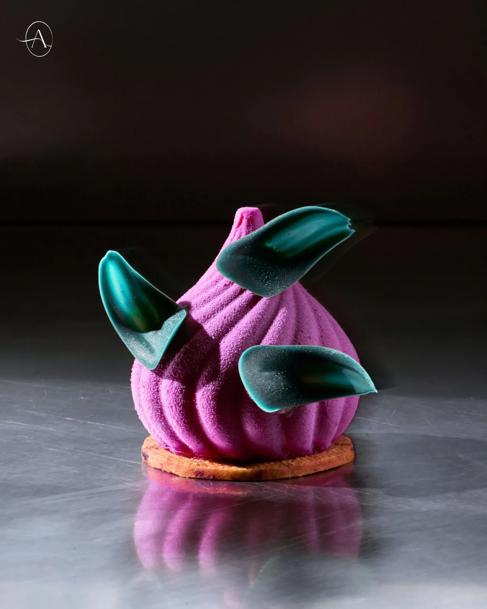 The Vanda Bloom-inspired pastry with purple mousse, teal chocolate petals, and a raisin cookie base