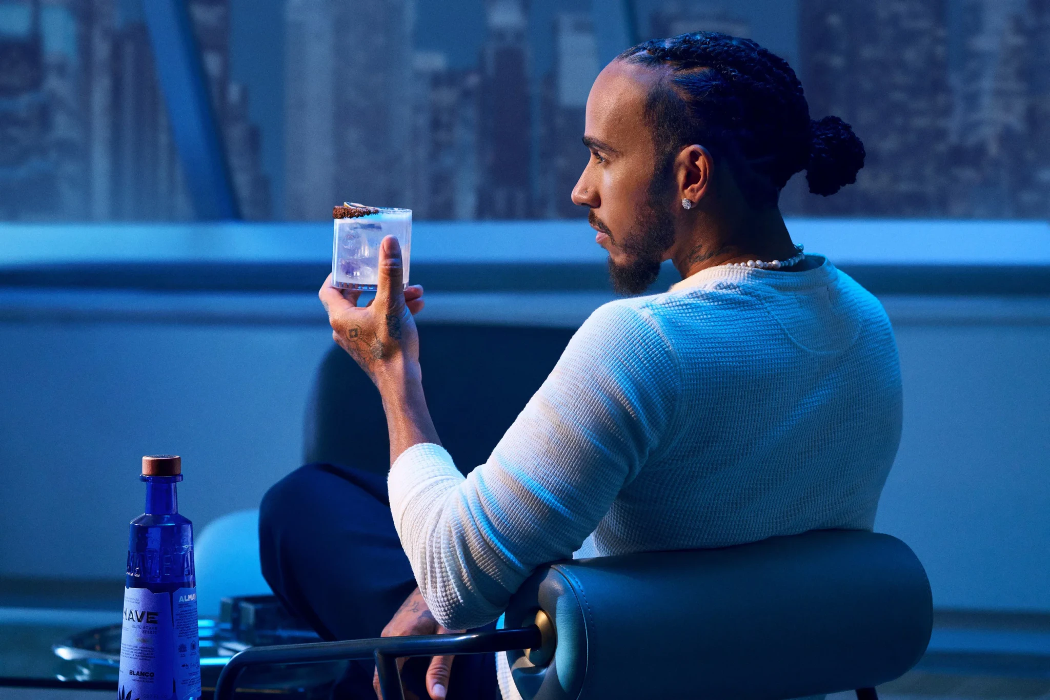 Lewis Hamilton holding a glass of Almave