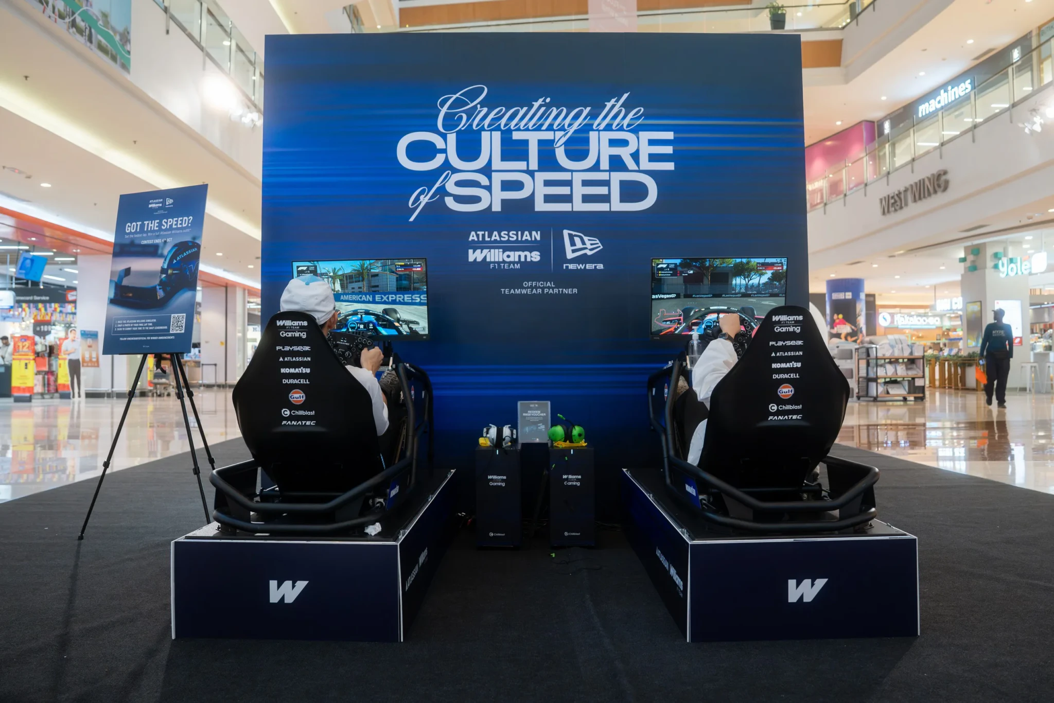 Two Williams-branded race car simulator pods set up side by side inside the New Era store at Bugis Junction