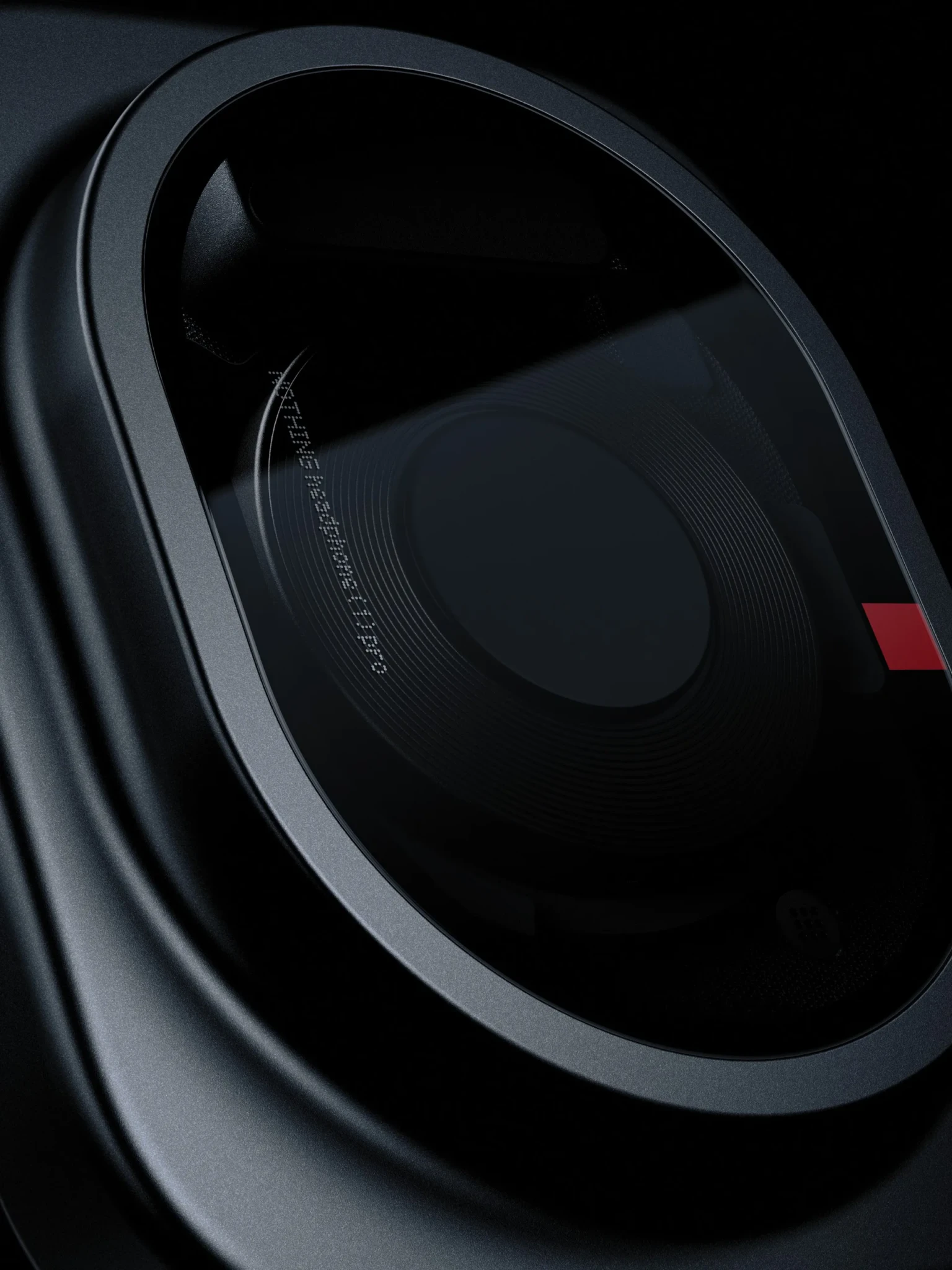 Close-up of Nothing Headphone (1) Pro headphone, dark grey shell with internal driver visible and red accent detail