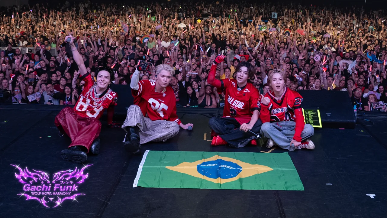 WOLF HOWL HARMONY performing on stage with a Brazilian flag