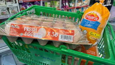 A FairPrice shopping basket holding a 30-egg tray and a Seara frozen griller pack