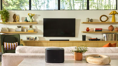 The JBL Cove X1 and JBL Cove P1 Wi-Fi speakers in a living room with a cream sofa and wooden media console