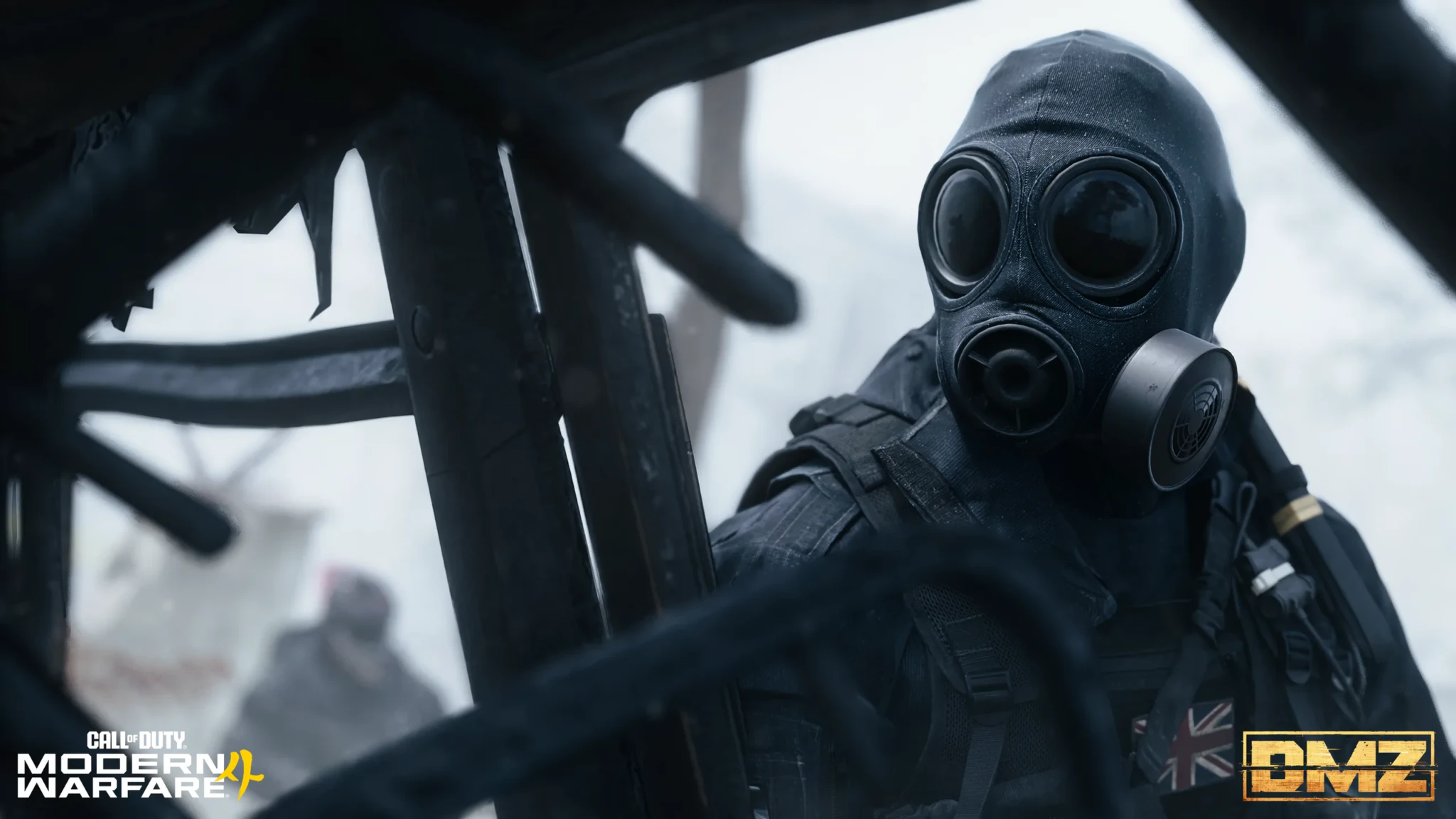An operator in a black gas mask and hood peering through charred wreckage in a snowy scene from Modern Warfare 4's DMZ mode