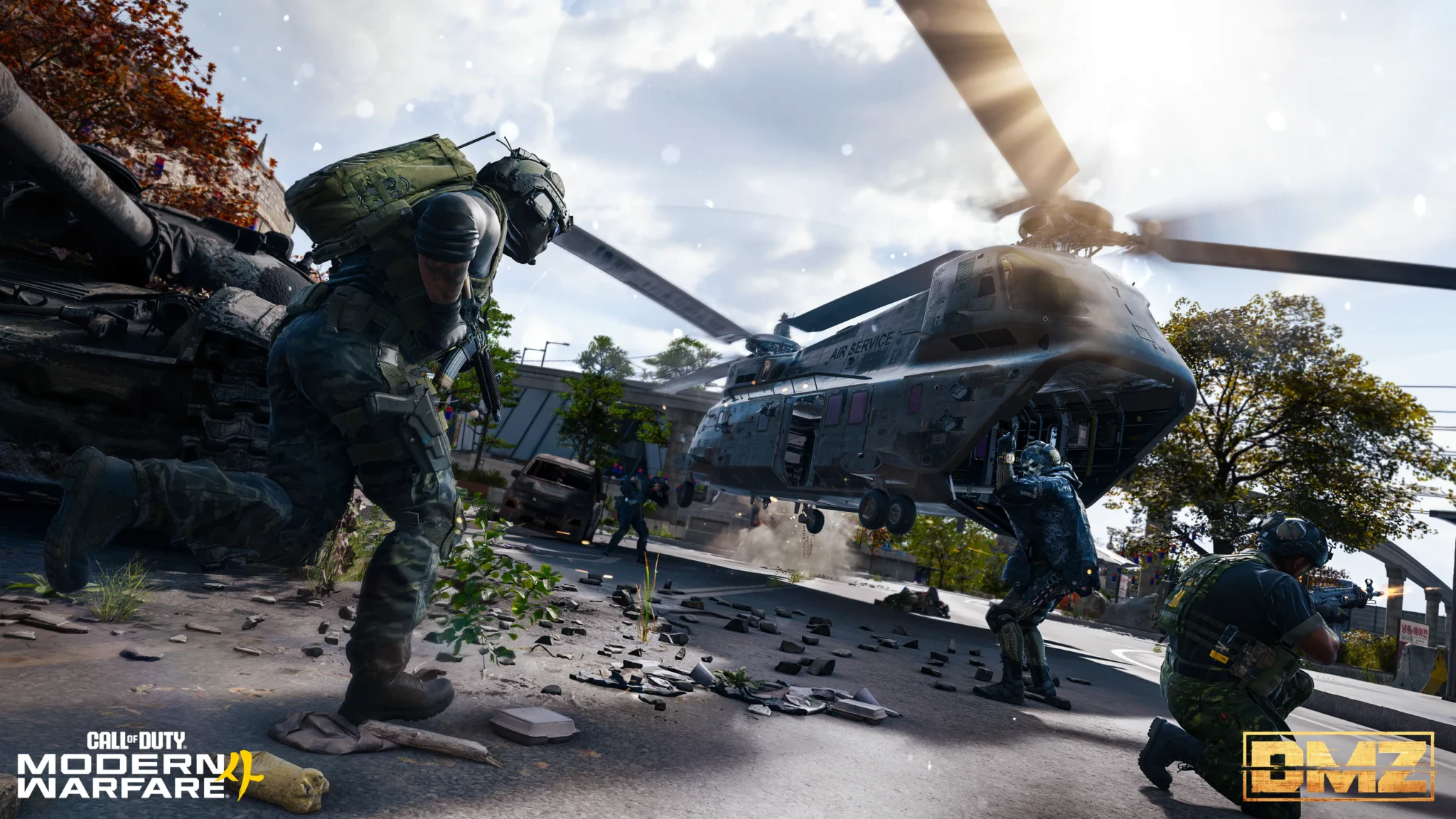Operators covering a twin-rotor helicopter marked Air Service as it lands on a debris-strewn street beside a wrecked tank