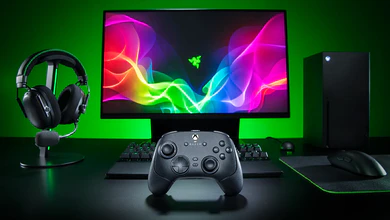 The Razer Wolverine V4 Pro wireless controller on a gaming desk with a keyboard, mouse, headphones, monitor and PC tower