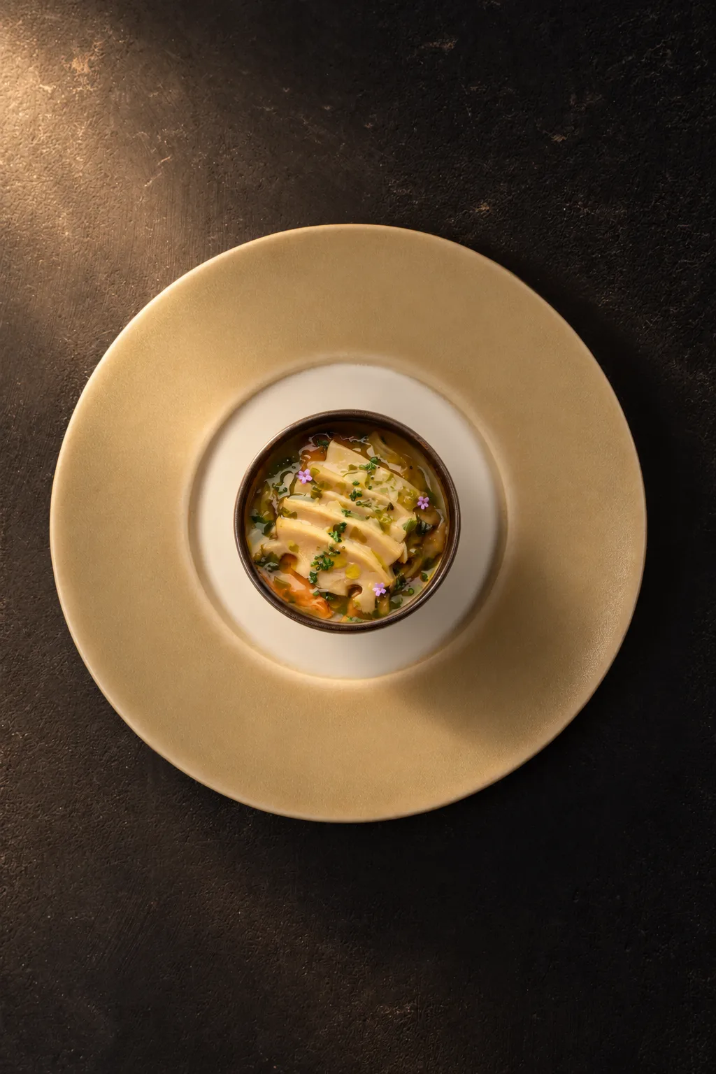 Sliced Abagold abalone on a savoury egg custard with mushrooms and edible flowers at AMI Patisserie