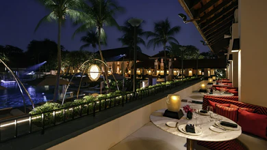 Kwee Zeen's outdoor dining terrace at Sofitel Singapore Sentosa at night.