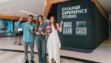 Four visitors holding merchandise inside Changi Experience Studio at Jewel Changi Airport