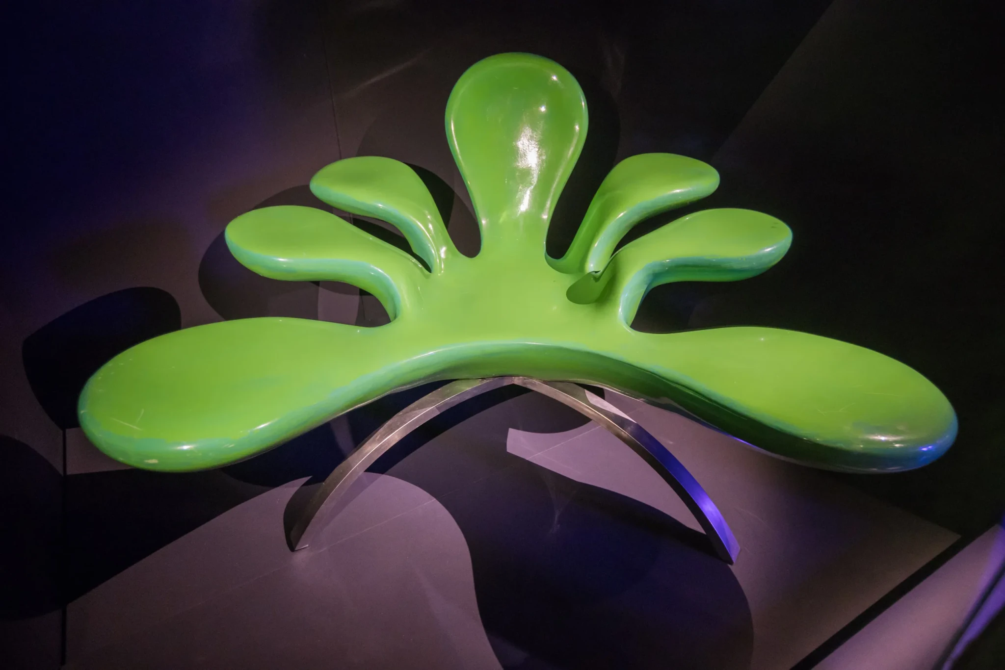 The green Septagon chair from Phuture at Zouk, with seven petal-like lobes on a curved metal base