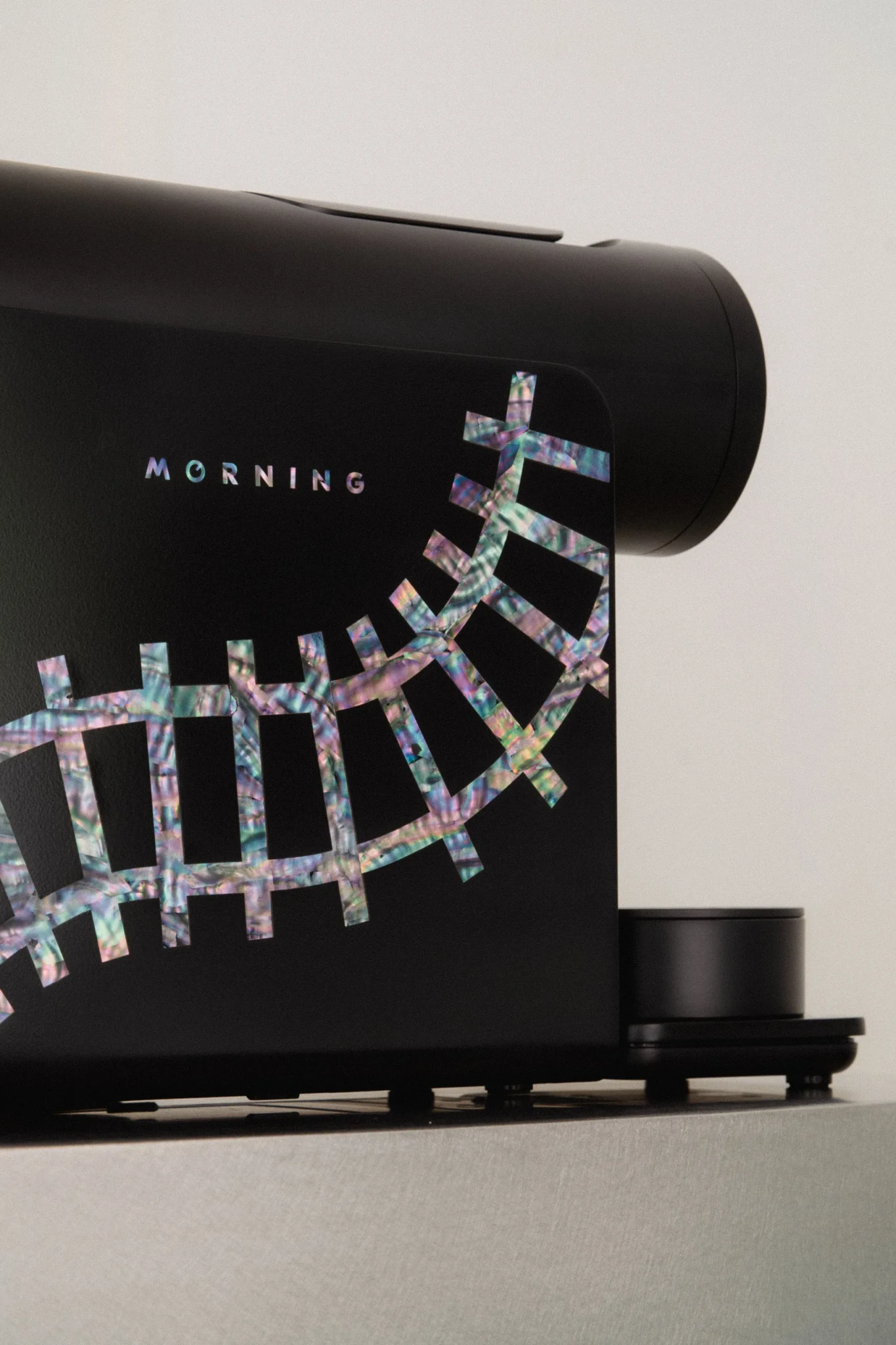 Black MORNING coffee machine with iridescent mother-of-pearl railroad-track inlay on its front panel