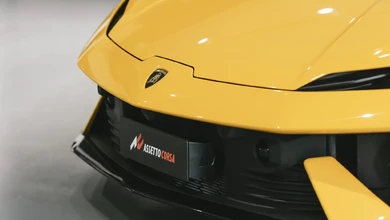 A yellow Lamborghini with the Assetto Corsa EVO logo on its front bumper