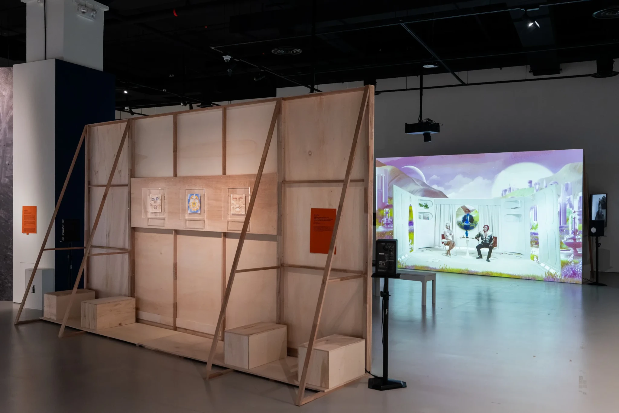 Installation view of Sin Wai Kin's The Time of Our Lives, a wooden pavilion with framed works and a video projection