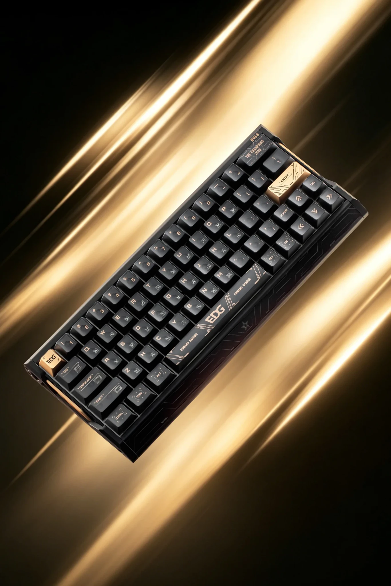 The black IQUNIX EV63 EDG Edition keyboard with gold accents, tilted against streaks of gold light