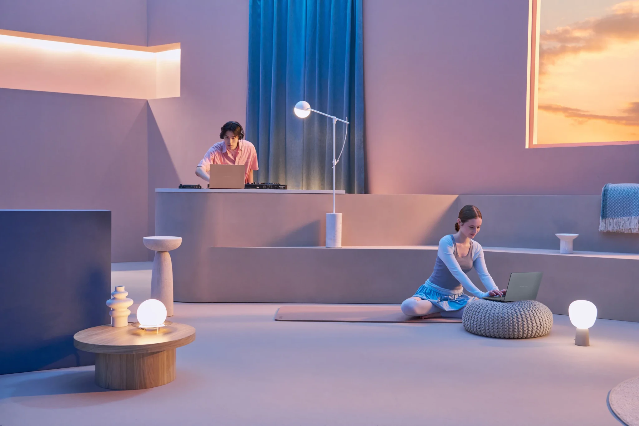 The Zenbook 14 in use at a desk and on the floor, in ASUS's staged lifestyle shot.