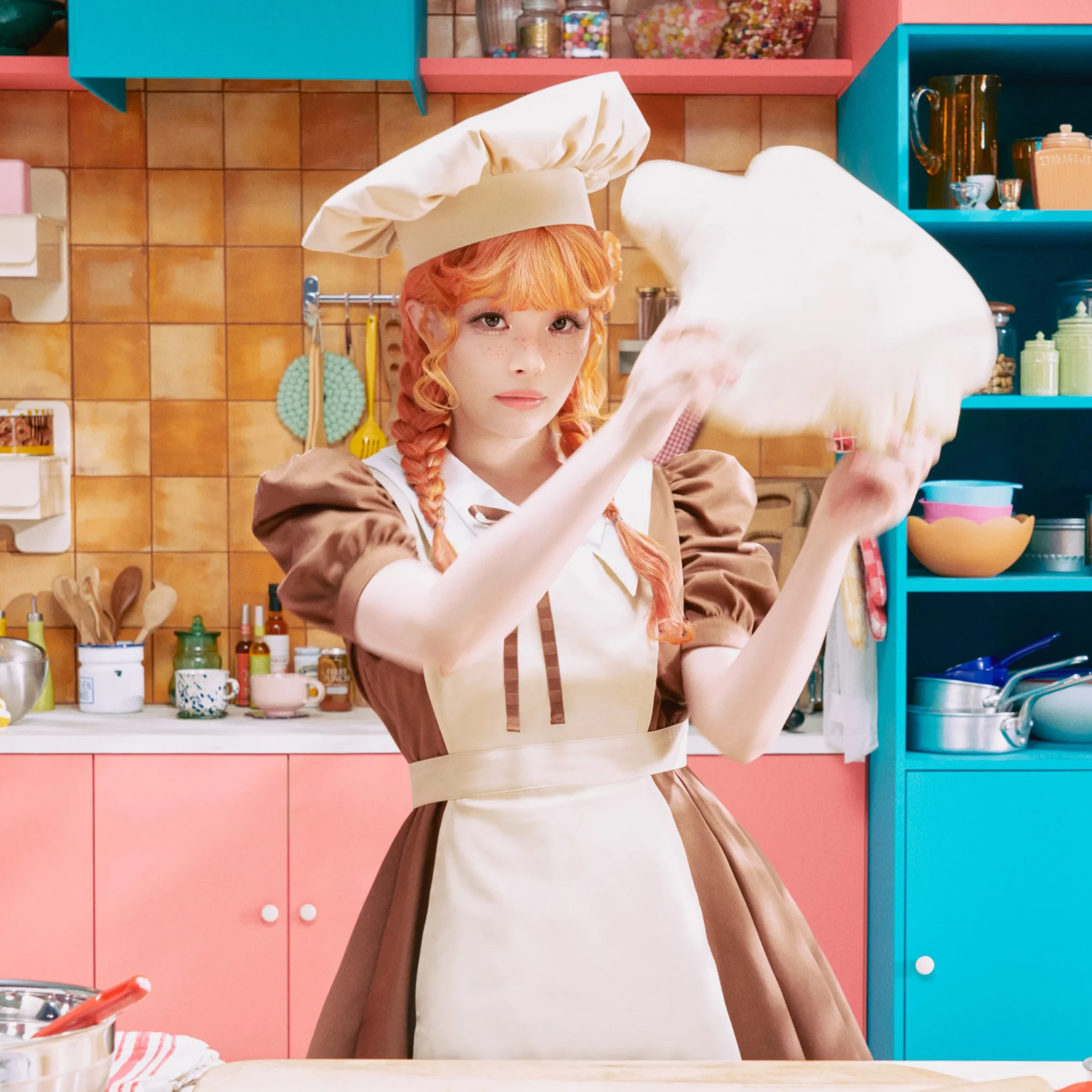 Kyary Pamyu Pamyu tossing dough in a baker's apron, from the Pang Pang Pang visuals