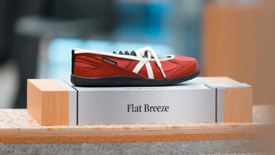 The red New Balance Flat Breeze on its display plinth.
